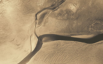 Aerial view of abstract sand dunes and dry riverbed patterns
