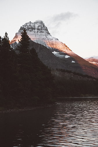 Snow-Capped Mountain Peak at Sunset Reflected in Lake