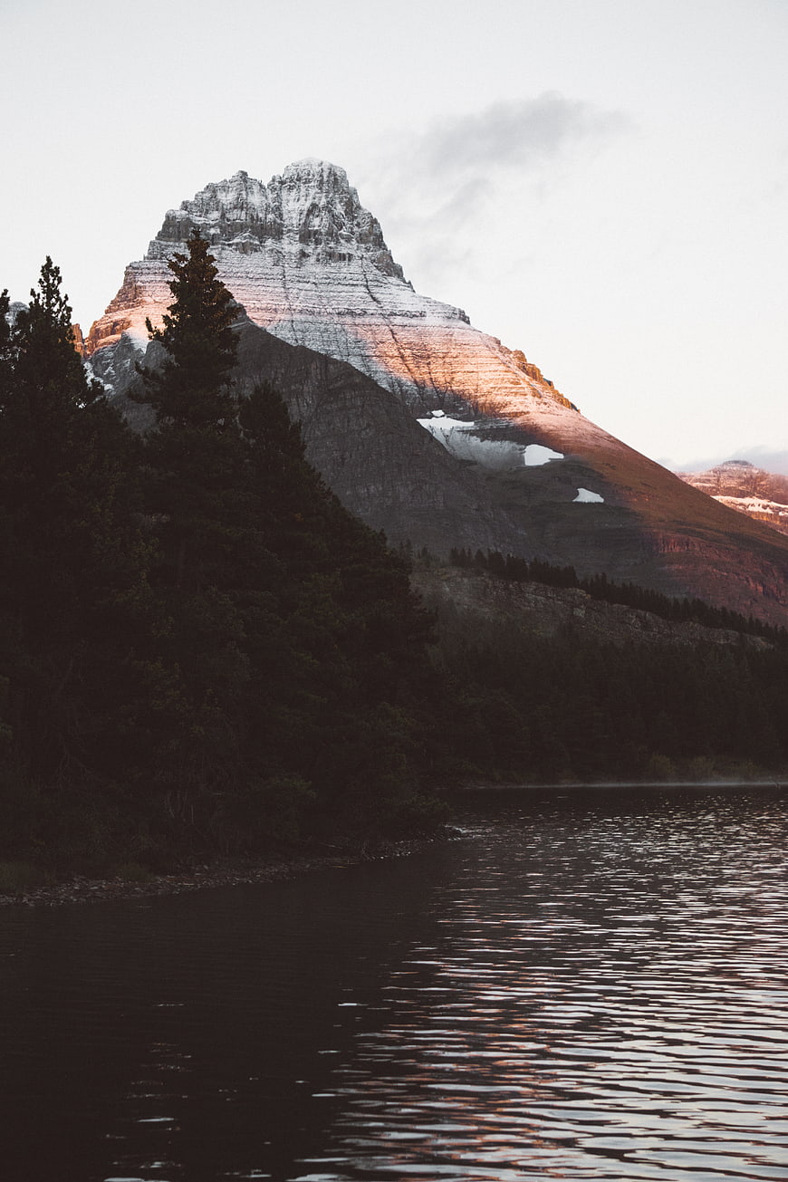 Snow-Capped Mountain Peak at Sunset Reflected in Lake