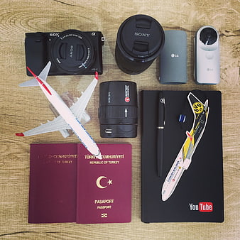 Travel photography gear flat lay with Turkish passport and camera