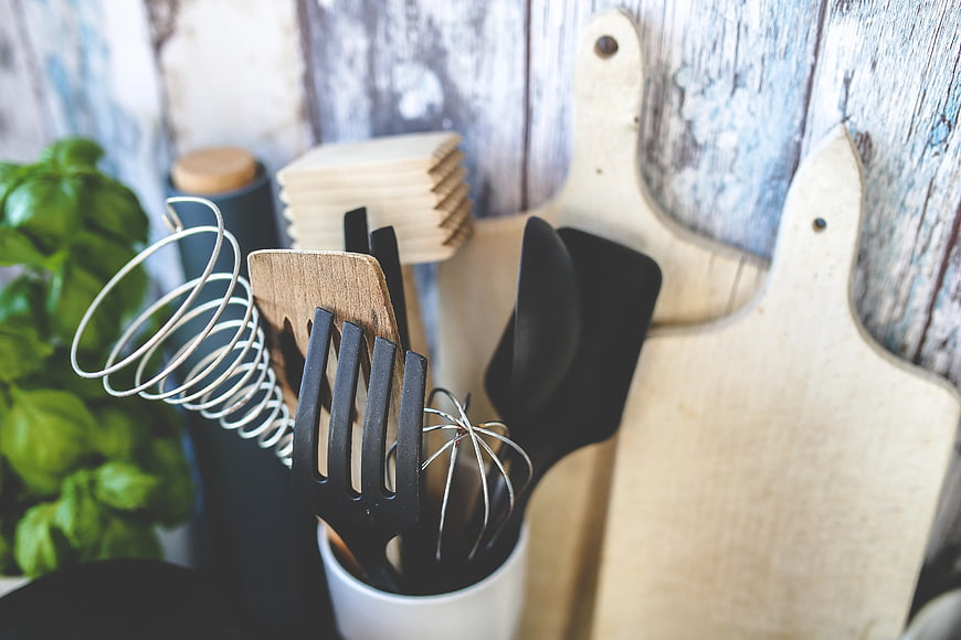 Kitchen Utensils and Wooden Cutting Boards on Rustic Background