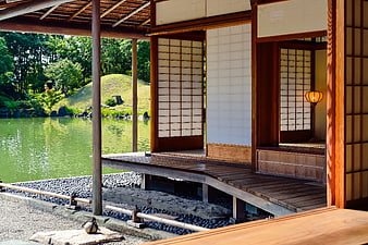 Traditional Japanese wooden house with garden and pond view