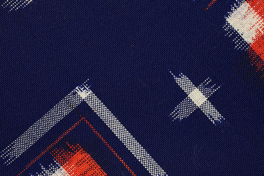 Close-up of blue plaid fabric with red and white pattern