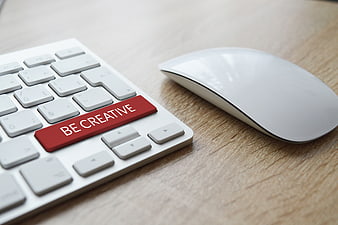 White Keyboard With Red Be Creative Key And Mouse On Wood