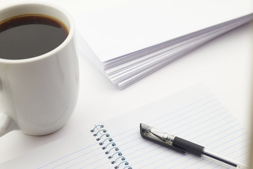 White Coffee Mug, Pen, and Notebook on Desk