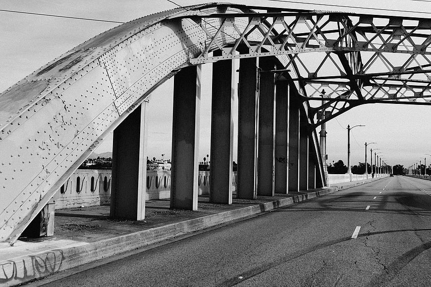 Black and white photo of steel truss bridge structure