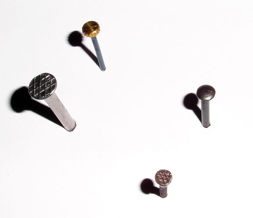 Assorted metal nails on white background