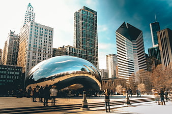 Cloud Gate sculpture in Chicago with skyscrapers and tourists