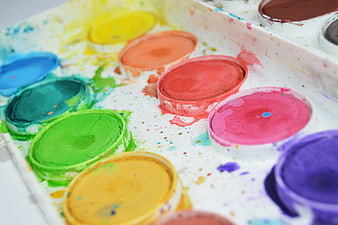 Close-up of colorful watercolor paint palette with splatters
