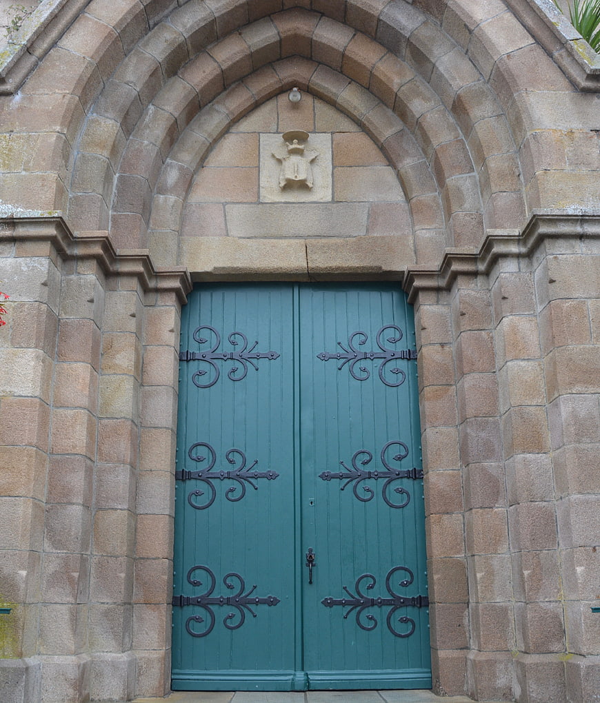 Historic Gothic Church Entrance With Teal Wooden Double Doors