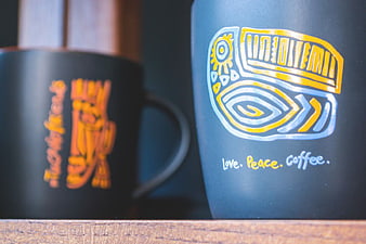 Blue coffee mug with love peace coffee text and graphic