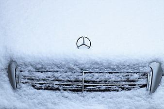 Mercedes-Benz car front grille buried in deep winter snow