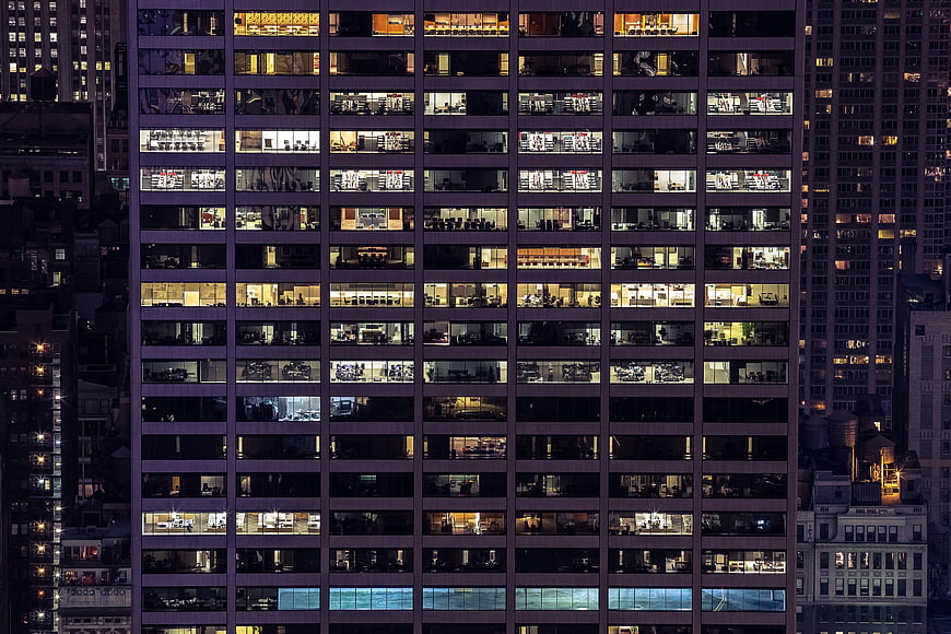 Night view of illuminated office building windows in city