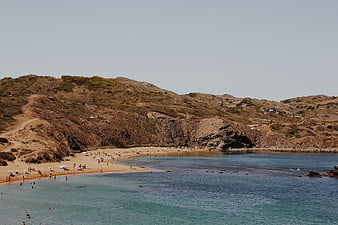 Scenic Mediterranean Beach with Turquoise Water and Arid Hills