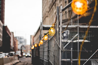 Orange Construction Lights on Urban Scaffolding Fence