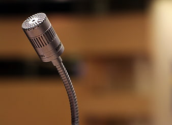 Close-up of silver gooseneck microphone on blurred background