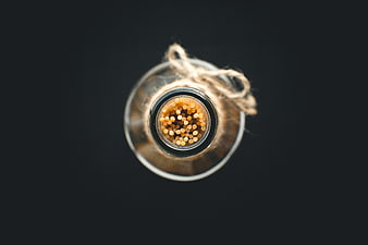 Top view of spaghetti in a glass bottle on black background