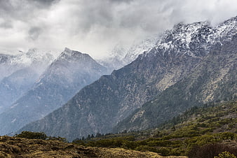 Majestic Snow-Capped Mountain Peaks Under Dramatic Clouds