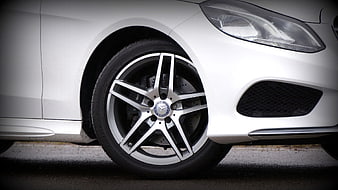 Close-up of white Mercedes-Benz car wheel and headlight