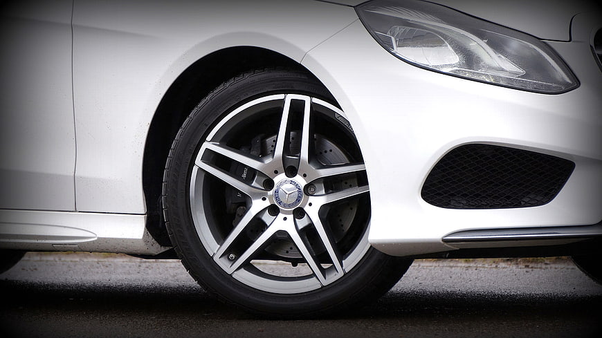 Close-up of white Mercedes-Benz car wheel and headlight