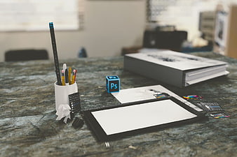 Graphic Designer Workspace with Photoshop Cube and Drawing Tools