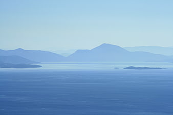 Serene Blue Mountain Landscape with Hazy Ocean View