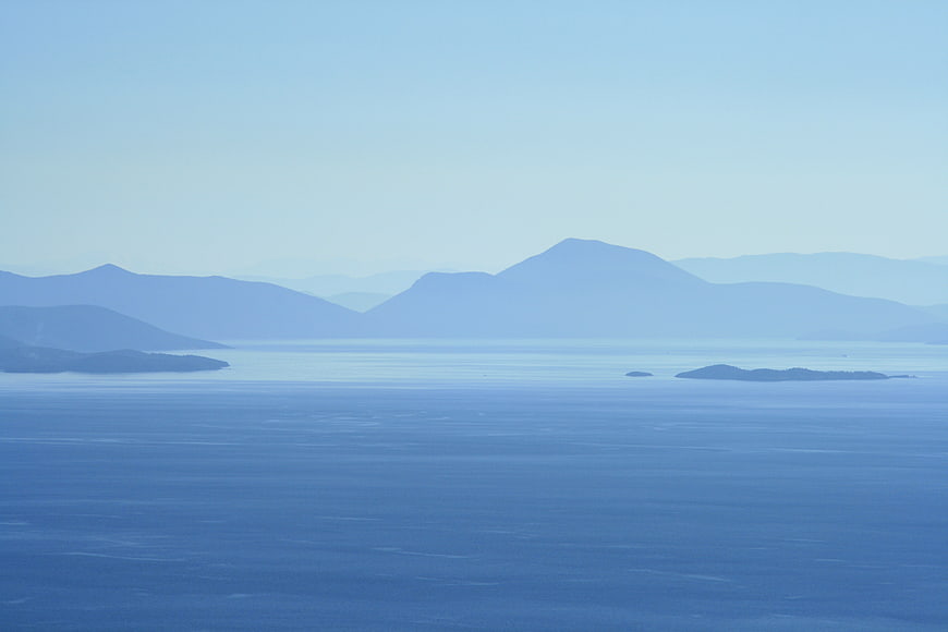 Serene Blue Mountain Landscape with Hazy Ocean View