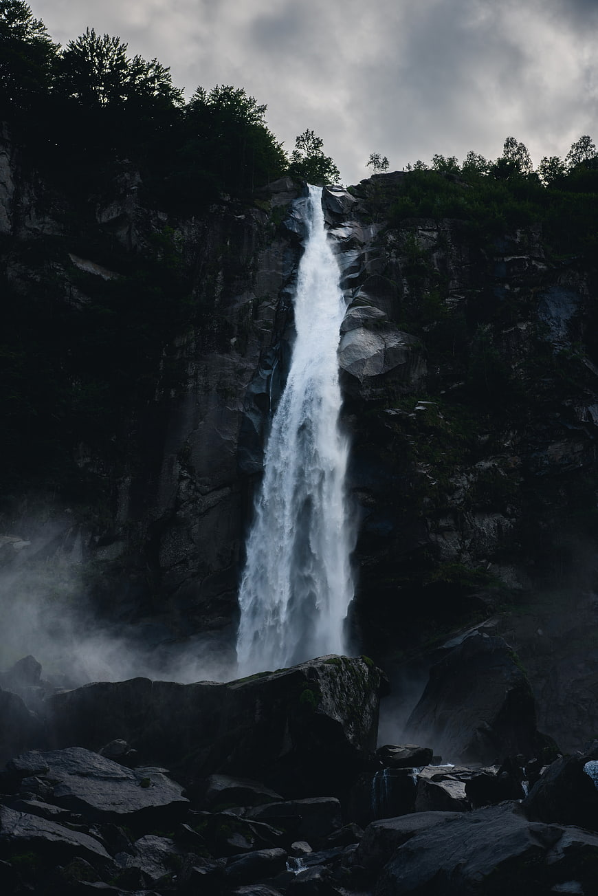 Dramatic waterfall cascading down dark rocky cliff