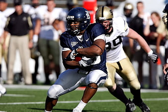 American Football Player Running with Ball in Action