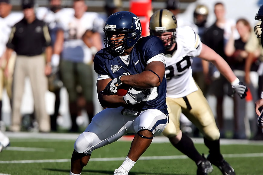 American Football Player Running with Ball in Action