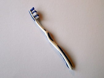 Blue and white toothbrush on white background