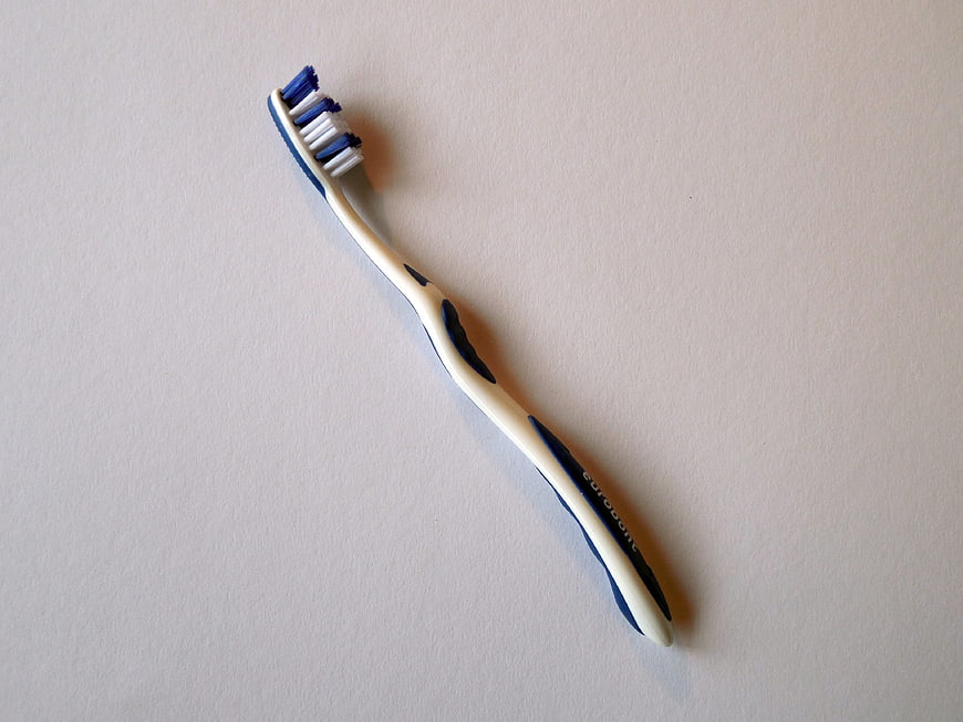 Blue and white toothbrush on white background