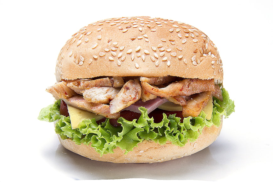 Delicious Chicken Sandwich with Lettuce and Cheese on White Background