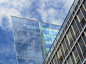 Modern Glass Office Building Architecture Against Blue Sky