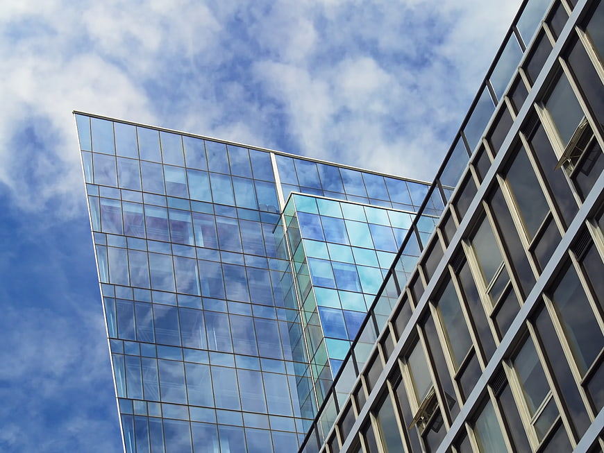 Modern Glass Office Building Architecture Against Blue Sky
