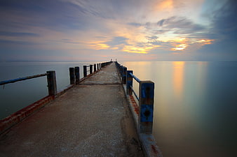 Long Exposure Sunset Pier Over Calm Ocean