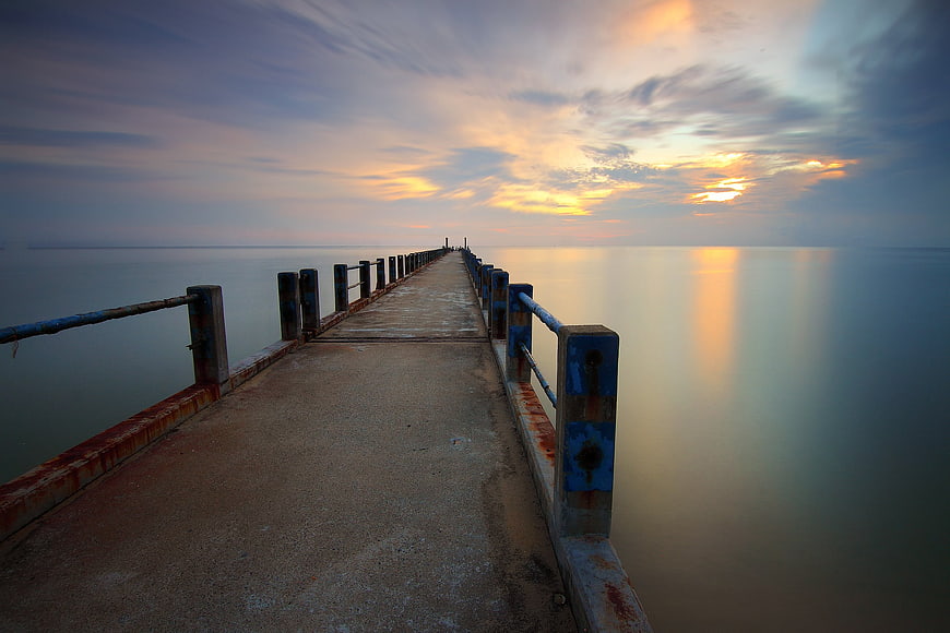 Long Exposure Sunset Pier Over Calm Ocean