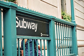 New York City Subway Entrance Sign on Green Gate