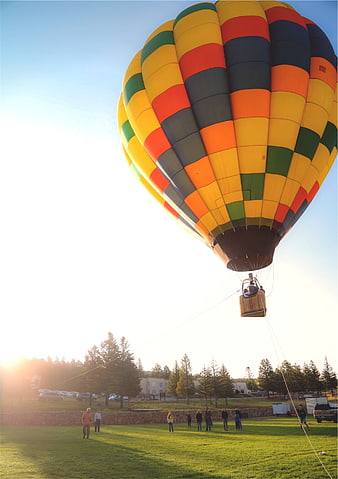 Colorful Hot Air Balloon Inflating on Grassy Field