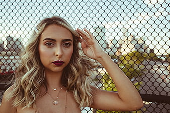 Stylish Blonde Woman Portrait with City Skyline Background