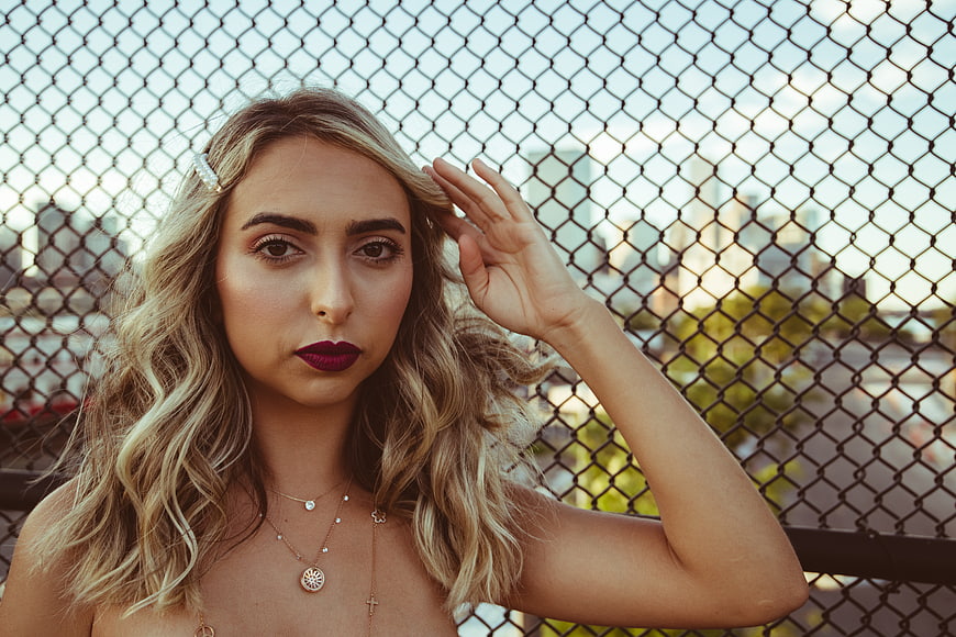 Stylish Blonde Woman Portrait with City Skyline Background