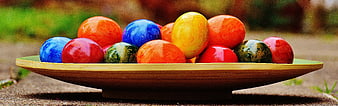 Colorful Easter Eggs in Wooden Bowl on Outdoor Table