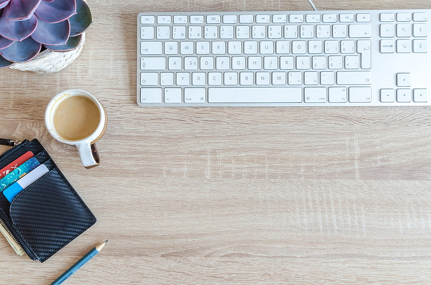 Top View Workspace With Keyboard, Coffee, Wallet, And Pencil On Wooden Desk