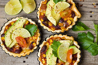 Three Mexican Avocado Tarts with Corn and Black Beans on Rustic Wood