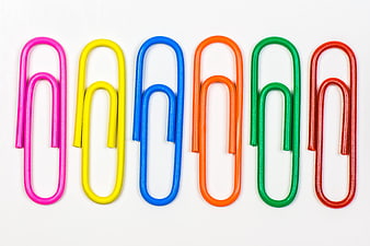 Colorful Paperclips Arranged in a Row on White Background