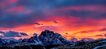Dramatic Sunset Over Snowy Mountain Peaks