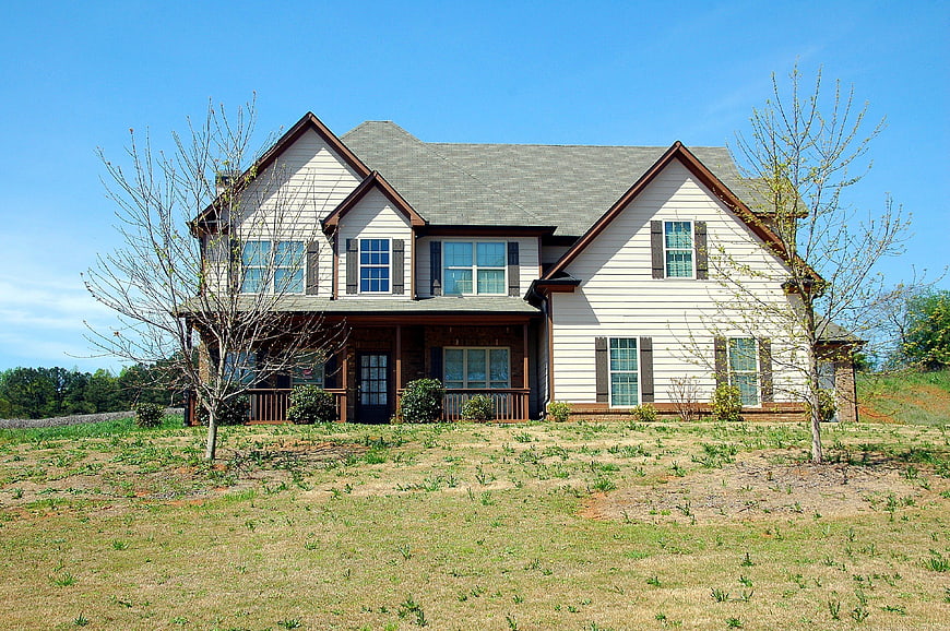 New two-story suburban home with white siding and brown trim