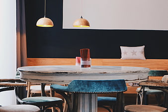 Modern Dining Room with Round White Table and Teal Chairs