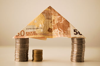 Euro banknote house on coin pillars