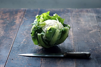 Fresh Cauliflower Head With Kitchen Knife On Rustic Dark Wooden Table